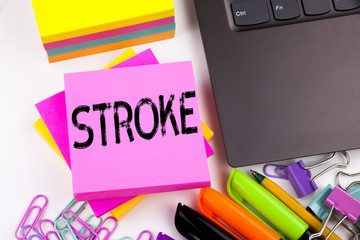 Writing text showing Stroke made in the office with surroundings such as laptop, marker, pen....