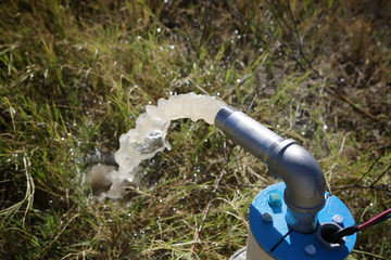Unfinished draw-well pumping the first underground water.