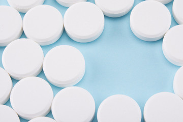 white pills on blue background