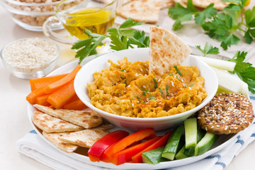 Arabic sauce hummus with fresh vegetables and pita bread