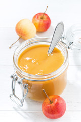 fresh apple sauce in a glass jar, vertical