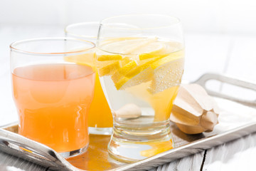 fresh citrus juice and water with lemon, closeup