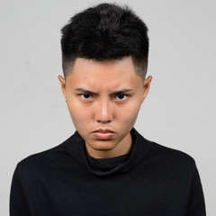 Portrait of Asian young tomboy looking angry