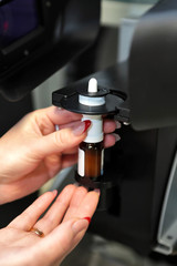 The worker measures the size of the particles and drops of the spray. Pharmaceutical industry and laboratory. Measurement of particle size with a laser. Malvern spraytec. Spray for the nose.