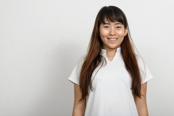 Portrait of beautiful Asian woman against white background