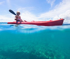 Fototapeta premium Woman in white swimwear on kayak explore blue sea. Split photo. Selective focus.