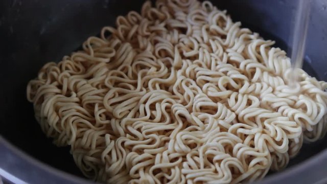	Put hot water into a bowl of instant noodles
