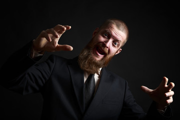 Crazy Funny face. Handsome businessman with beard and handlebar mustache looking at camera