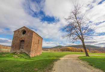 Fototapeta na wymiar Abbey of Saint Galgano (Italy) - An old cistercian catholic monastery in a isolated valley of Siena province, Tuscany region. The roof collapsed after a lightning strike on the bell tower.