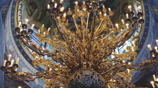 The chandeliers and the frescoes in the Church. Gorgeous and ancient iconostasis in the Cathedral of St. Petersburg. 4k, 3840x2160