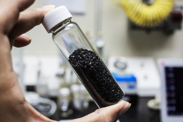 activated carbon or granular in clear bottle is used in air purification, decaffeinate, gold purification, metal extraction, water purification, medicine, sewage treatment, air filters in gas masks - obrazy, fototapety, plakaty