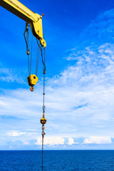 Blue sky and white cloud with auxiliary and main hook crane.