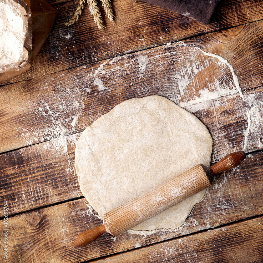 Poster Roll out dough with rolling pin and flour