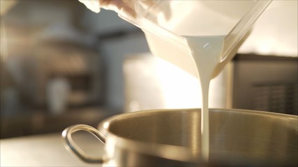 Ice-cream production. Mix ice cream. Pour the milk into a pan