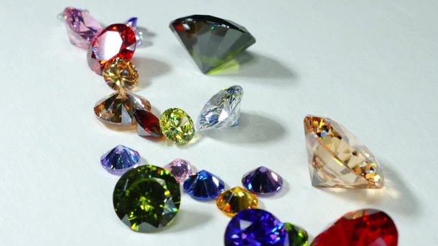 colorful gemstones are displayed on the white floor
