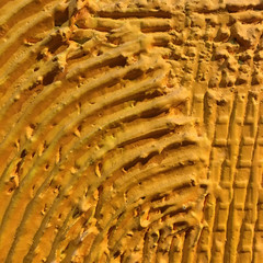 Yellow surface, low abrasive scratching, construction.