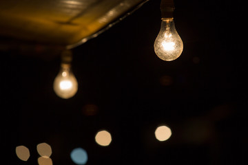 Old dusty light bulb glowing in the dark