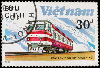 Old vintage postage stamp with soviet locomotive and railway, printed in Vietnam in 1988