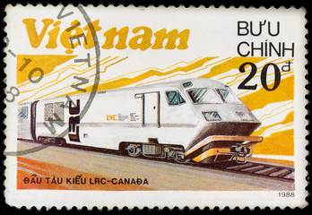 Old vintage postage stamp with canadian locomotive and railway, printed in Vietnam in 1988