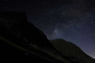 Stars in the night sky over the mountains. View of the Milky Way.