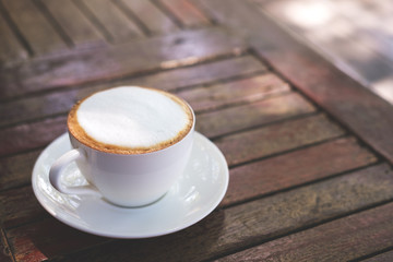 Hot coffee on wooden table