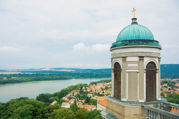 Panoramic aerial view over the roofs of Esztergom town near Budapest, Danube river and a tower of Esztergom Cathedral at the foreground.