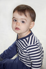 Fototapeta premium Boy toddler close up sitting on the floor/Boy toddler closeup portrait