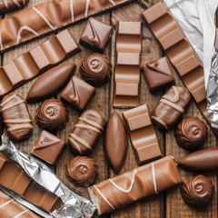 Background of chocolates, bars and sweets, free space for text, close up