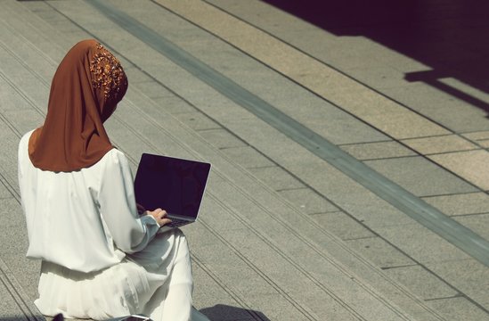 One Muslim woman is working outside the office