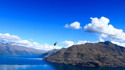 helicopter flying above the mountains and Lake Wakatipu, Queenstown © Veronika