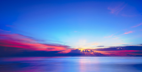 Fototapeta premium Sunset dramatic colorful tropical sea sky and cloud background,Long exposure image