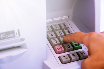 pressing the button in front of atm machine 