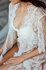 Obraz na płótnie Canvas Beautiful bride in lingerie and white dress