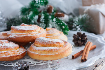 Traditional Christmas Swedish pastries - Kanelbulla (buns with cinnamon) with powdered sugar, horizontal