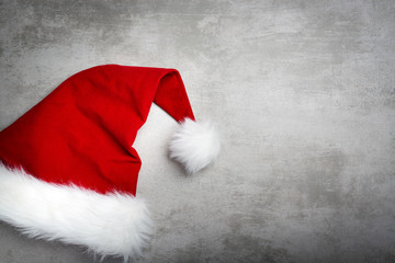 Red santa hat on a gray concrete table