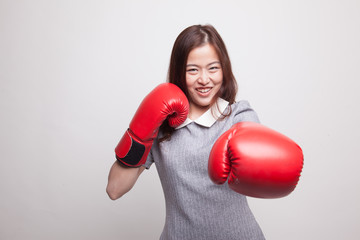 Young Asian woman with red boxing gloves.