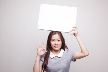 Young Asian woman show OK with  white blank sign.