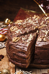 Cut a piece of Christmas chocolate walnut cake, selective focus