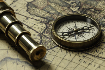 Retro compass with old map and spyglass