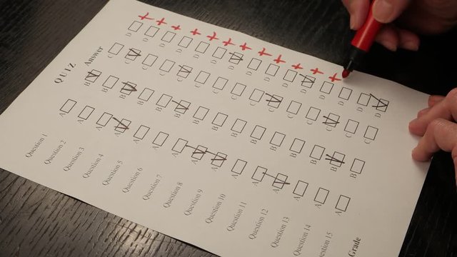 Teacher checks the answers of the test tasks and puts a perfect  grade