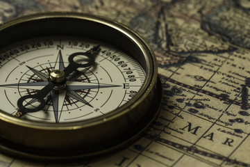 Retro compass with old map