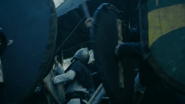 Medieval Battle Reenactment. Violent Tribe of Warriors Attack Guards and Civilians in the Wooden Fortress. Shot on RED EPIC-W 8K Helium Cinema Camera. 