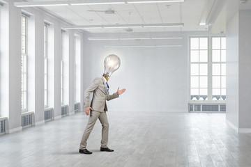 Fototapeta premium Bulb headed businessman. Mixed media
