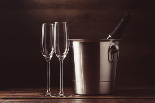 Picture of two empty wine glasses, bottle of wine