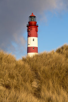 Amrum Lighthouse behind sand dunes on a sunny Winters day, Amrum island, Schleswig-Holstein, Germany, Europe