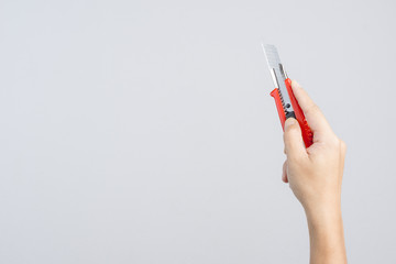 Hand holding office big paper cutter