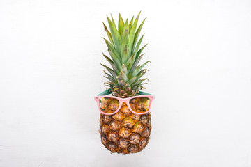 Fashion Hipster Pineapple Fruit. Tropical pineapple with Sunglasses. Creative Art concept. Top view. Free space for text.