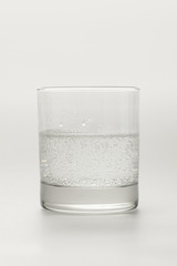 Glass with sparkling mineral water isolated on white
