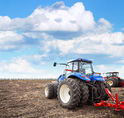 Agricultural machinery cultivates the field