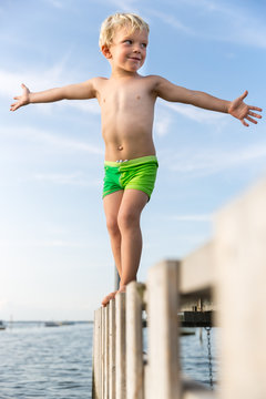 Boy (4 years) balancing on a jetty, Gedser, Falster, Denmark